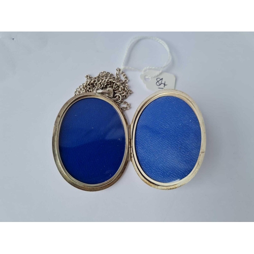 84 - A very large silver locket (5.5cm long) with floral scroll decoration on silver chain