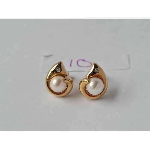 10 - A pair of diamond set pearl earrings 18ct gold