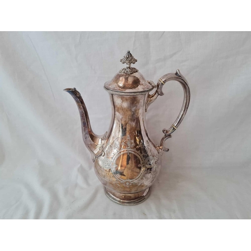 1003 - A Victorian coffee pot engraved with strap work