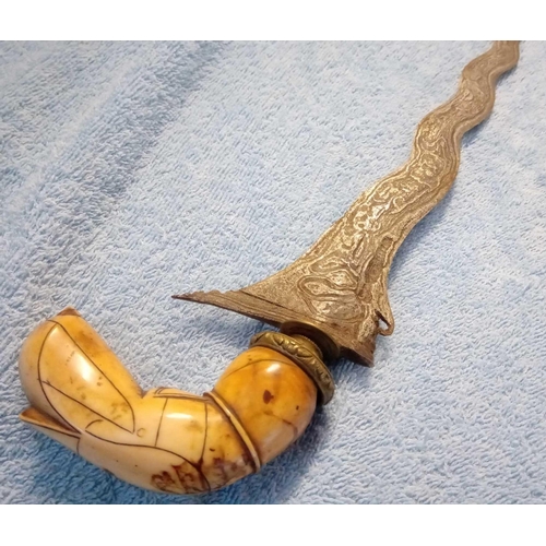 1087 - Another Eastern dagger with bone handle wavey blade and wood sheath 15 inches long