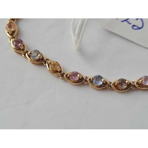 125 - A attractive multi coloured sapphire line bracelet 9ct - 7.5 gms inc