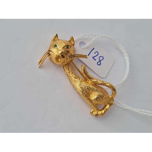 128 - A yellow metal designer brooch in the form of a cat with green stone eyes marked P&M Paris