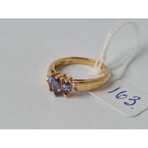 163 - A three stone tanzanite ring 18ct gold size N - 4.3 gms