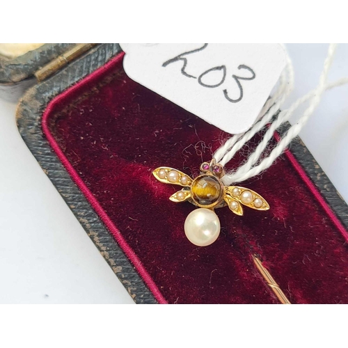 203 - A gold fly stick pin with small garnet eyes and pearl and cats eye body in fitted case