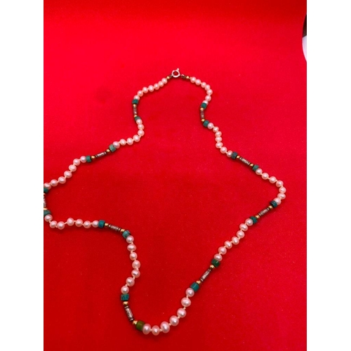 257 - A fresh water pearl necklace interspersed with turqouise matrix and gold and silver beads