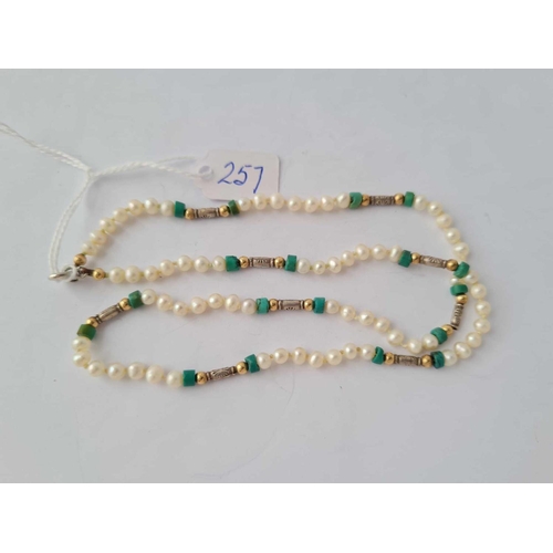 257 - A fresh water pearl necklace interspersed with turqouise matrix and gold and silver beads