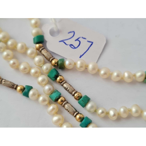 257 - A fresh water pearl necklace interspersed with turqouise matrix and gold and silver beads