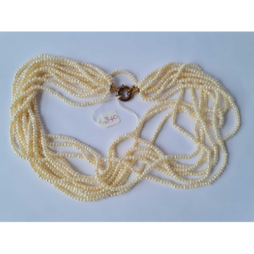 340 - A ten strand pearl necklace with circular gilt clasp