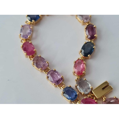 353 - A COLOURED SAPPHIRE LINE BRACELET SET IN GOLD