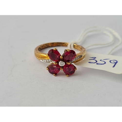 359 - A good garnet and diamond clover leaf design ring with four large garnets with central diamonds and ... 