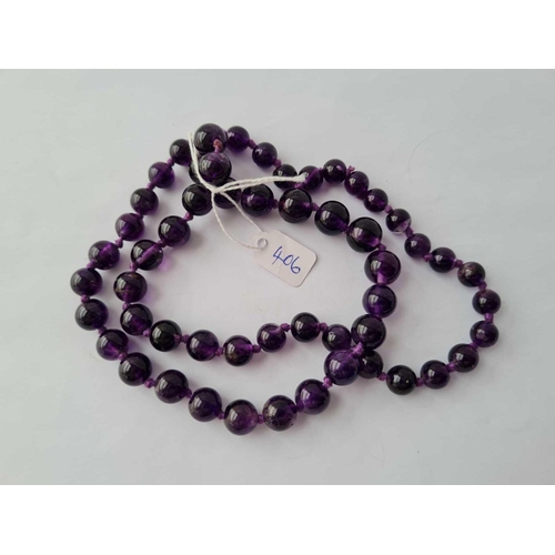 406 - A good long graduated amethyst bead necklace 64 cms length