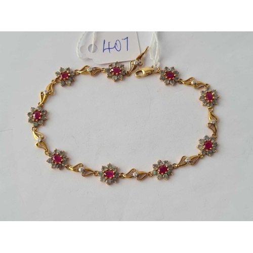 407 - AN ATTRACTIVE FANCY LINK BRACELET WITH NINE RUBY AND ALEXANDRITE CLUSTERS IN 9CT GOLD - 5.4 GMS INC ... 