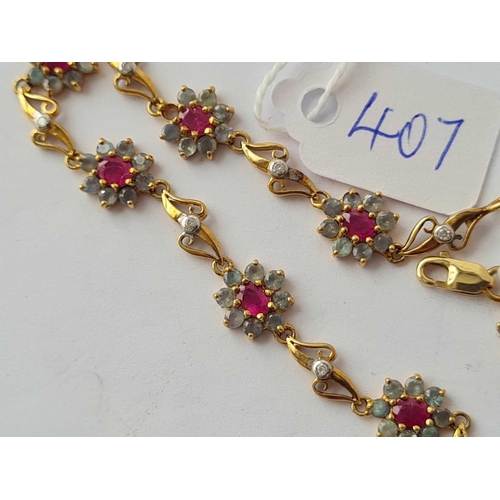 407 - AN ATTRACTIVE FANCY LINK BRACELET WITH NINE RUBY AND ALEXANDRITE CLUSTERS IN 9CT GOLD - 5.4 GMS INC ... 