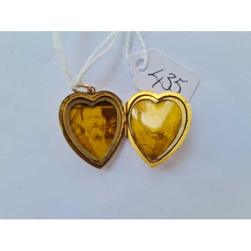 435 - A gold back & front stone set heart locket