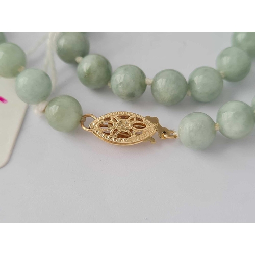 457 - A jadeite bead necklace with 14ct gold clasp