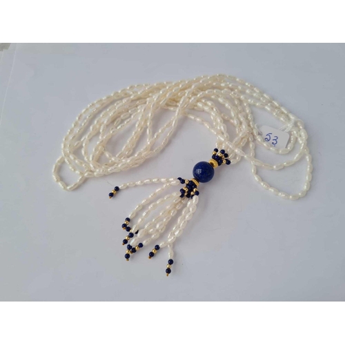 53 - A three strand fresh water pearl and lapis bead necklace