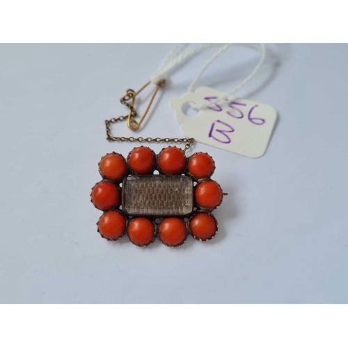 556b - An antique gold set coral brooch