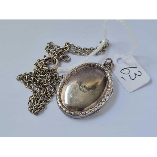 63 - A silver locket on silver chain 12.7g