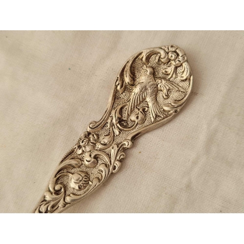 702 - A large cast decorative continental spoon, the bowl embossed with sailing boat - 81 g.