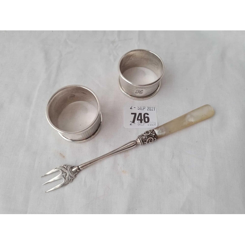 746 - Two napking rings and a pickle fork by GU