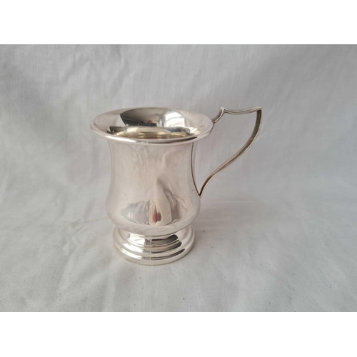 856 - A plain christening mug baluster shaped with scroll handle - 3.5