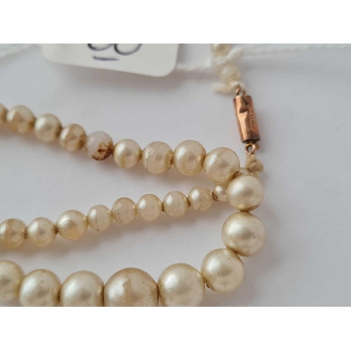 60 - A small childs pearl necklace with gold barrel clasp