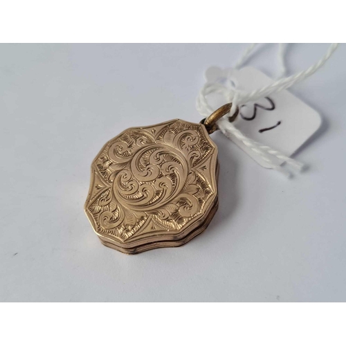 31 - A fancy scroll engraved gold back & front locket
