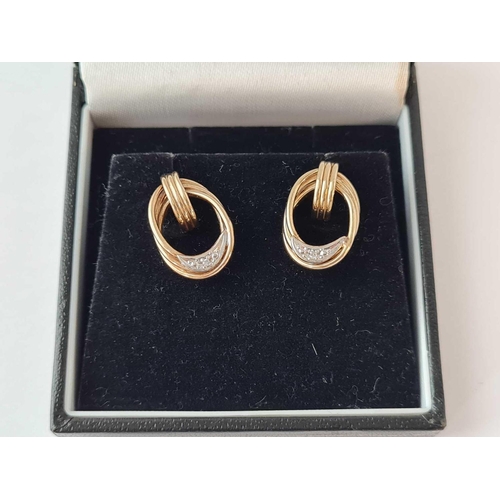 102 - A pair of boxed diamond earrings 9ct - 2.4 gms