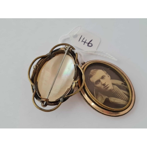 146 - A rolled gold oval double photo locket together with a gilt oval MOP brooch