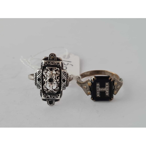 150 - A antique silver ring together with early metal onyx initial H ring