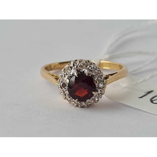 166 - A garnet and diamond cluster ring 18ct gold size M - 2.9 gms