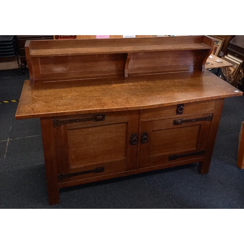 1682 - A Liberty & Co Arts and Crafts oak sideboard with iron escutions  6ft.3 wide