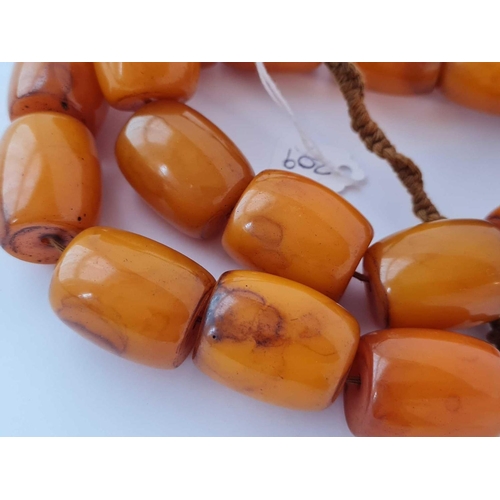 209 - A large Tibetan amber bead necklace 29 inches - 244 gms