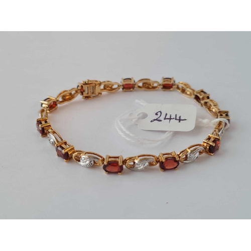 244 - A GOLD DIAMOND AND GARNET TENNIS BRACELET 9CT - 10.5 GMS