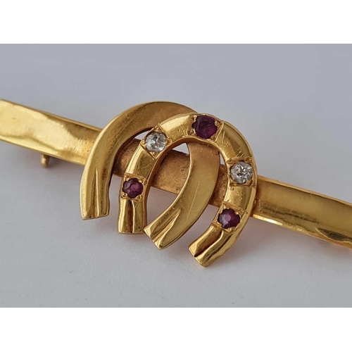 264 - An antique 22ct gold double horseshoe brooch set with ruby & diamond 5.7g inc