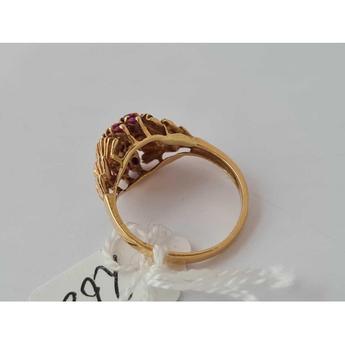 268 - A ruby cluster ring in 18ct gold size K 3.6g inc