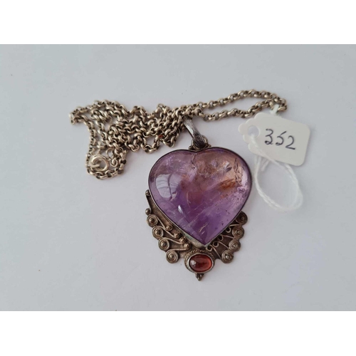 352 - A silver heart shaped cabochon amethyst and garnet set pendant and chain