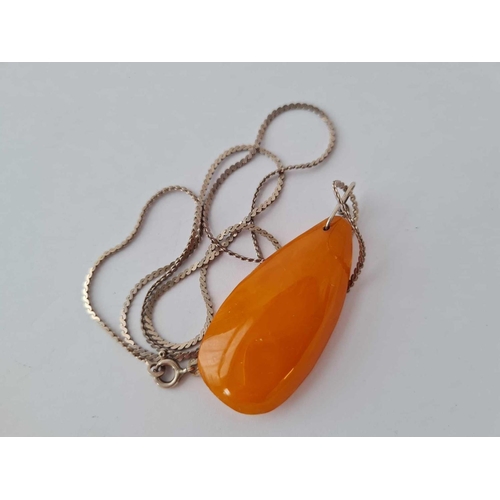 353 - A butterscotch amber and silver pendant - 5 gms on silver chain - 4.6 gms and butterscotch amber and... 