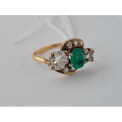 380 - A STUNNING 0.63 CT OVAL EMERALD AND 0.90 CT AND 0.17 CT  DIAMOND THREE STONE  RING WITH SIX DIAMOND ... 