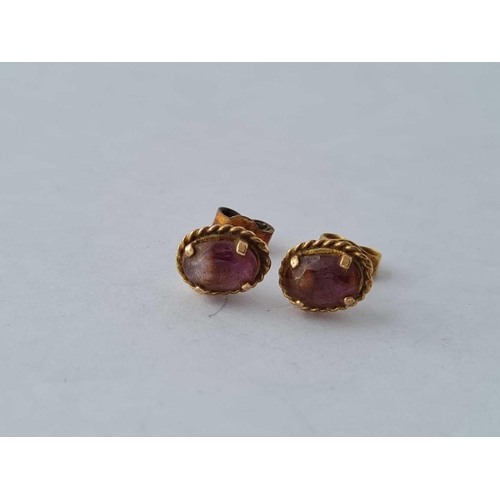 384 - A pair of amethyst ear studs 9ct - 1.5 gms