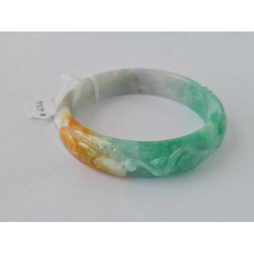 424 - Green & white carved hardstone bangle, interior diameter 62mm