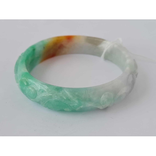 424 - Green & white carved hardstone bangle, interior diameter 62mm