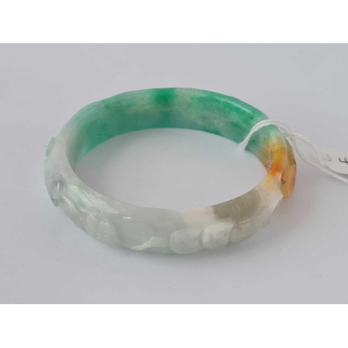 424 - Green & white carved hardstone bangle, interior diameter 62mm