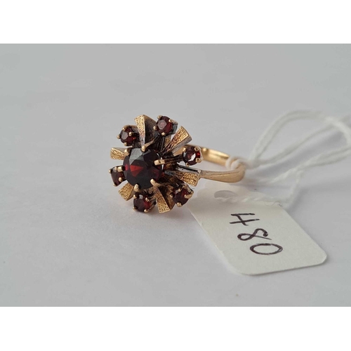 480 - A garnet set star bust cluster ring 9ct size L 1/2 - 4.3 gms