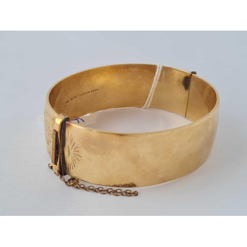 490 - A rolled gold engraved hinged bangle