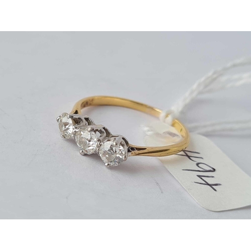 494 - A three stone diamond ring in high carat gold size P 1/2