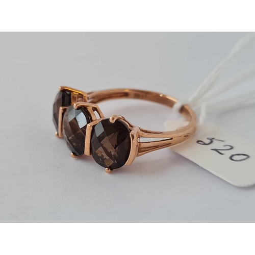 520 - A large dress ring set with three Smokey quartz 9ct size U - 3.8 gms