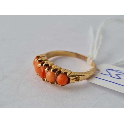 536 - A five stone coral ring 18ct gold size O - 3.6 gms