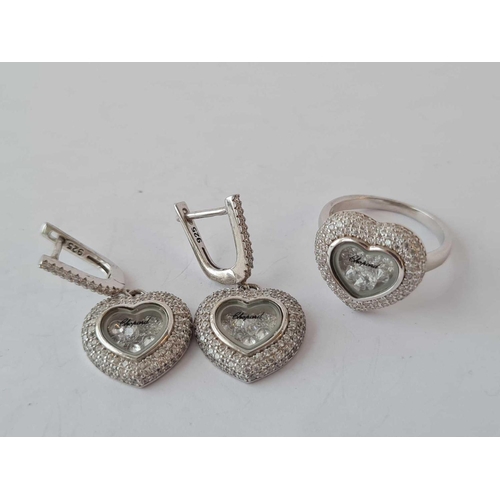 563 - A sweet of silver heart shaped stone set jewellery consisting of ring pendant and earrings