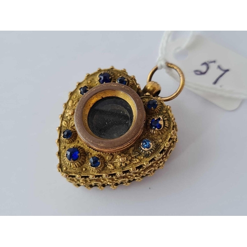 57 - A Victorian novelty yellow metal paste set heart pendant with magnifying telescopic eye glass centre